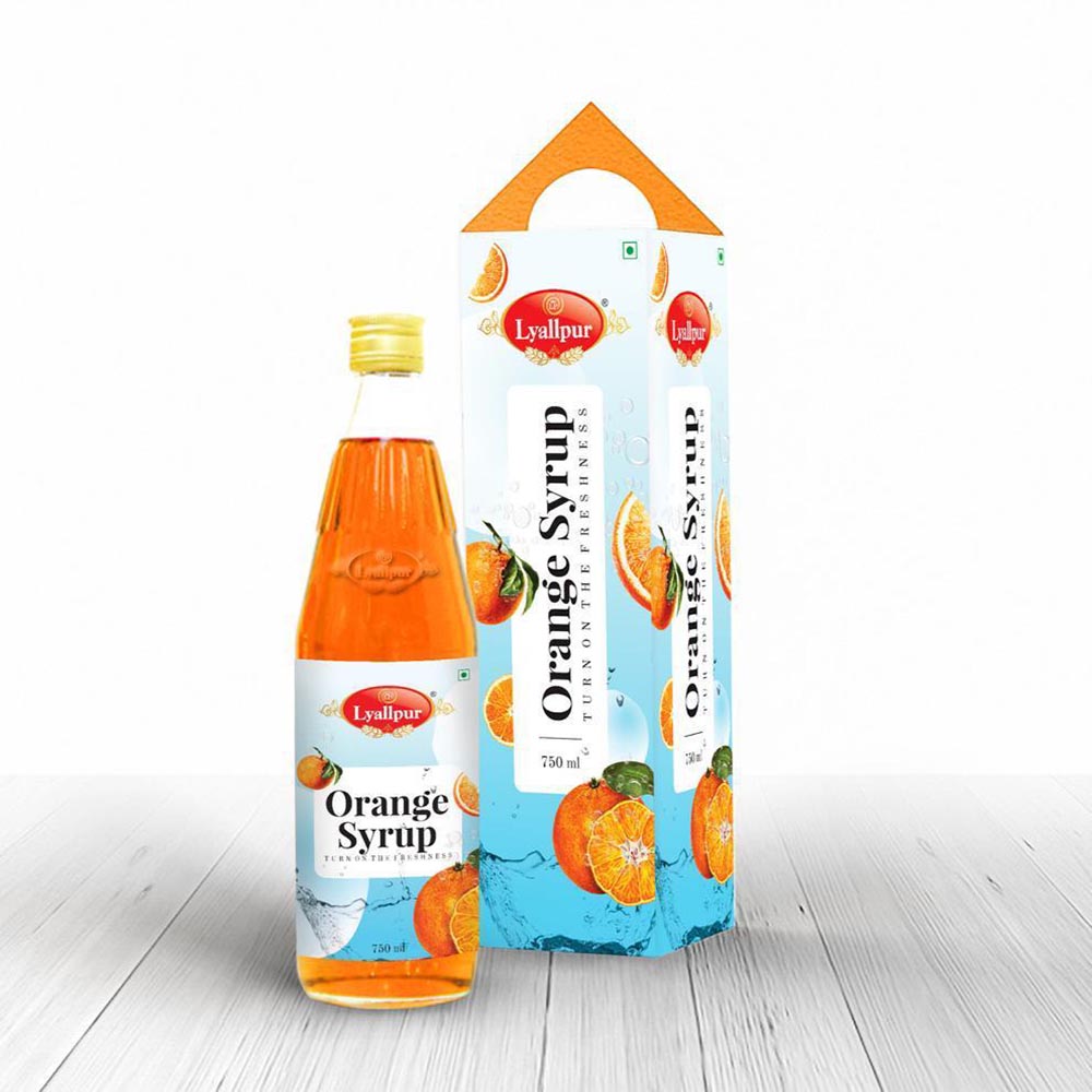 A bottle of orange syrup placed beside a box, showcasing its vibrant color and packaging design.